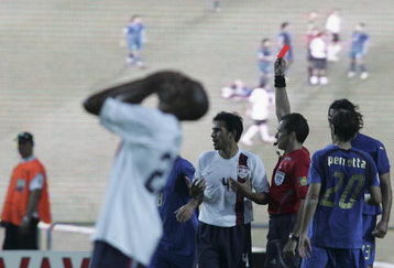 KAISERSLAUTERN, GERMANY - JUNE 17:  Eddie Pope #23 of the USA, holds his head in his hands as teammate Pablo Mastroeni #4 (C), is shown the red card by Referee Jorge Larrionda of Uruguay during the FIFA World Cup Germany 2006 Group E match between Italy and USA at the Fritz-Walter Stadium on June 17, 2006 in Kaiserslautern, Germany.  (Photo by Ben Radford/Getty Images)