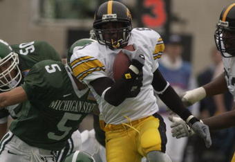 EAST LANSING, MI - OCTOBER 13:  Wide receiver CJ Jones #8 of the Iowa Hawkeyes runs past safety Lorenzo Guess #5 of the Michigan State Spartans during the Big Ten Conference football game on October 13, 2001 at Spartan Stadium in East Lansing, Michigan. The Spartans edged the Hawkeyes, 31-28. (Photo by Darron R. Silva/Getty Images)