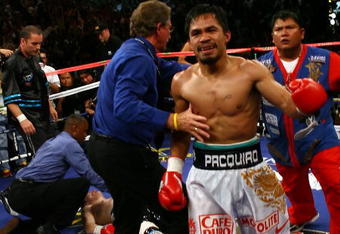 LAS VEGAS - MAY 02:  (R-L) Manny Pacquiao of the Philippines reacts after knocking out Ricky Hatton of England in the second round during their junior welterweight title fight at the MGM Grand Garden Arena May 2, 2009 in Las Vegas, Nevada.  (Photo by Al Bello/Getty Images)