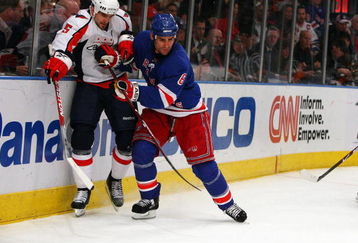 NEW YORK - APRIL 22:  Wade Redden #6 of the New York Rangers defends against Boyd Gordon #15 of the Washington Capitals  during Game Four of the Eastern Conference Quarterfinal Round of the 2009 NHL Stanley Cup Playoffs on April 22, 2008 at Madison Square Garden in New York City.  (Photo by Jim McIsaac/Getty Images)