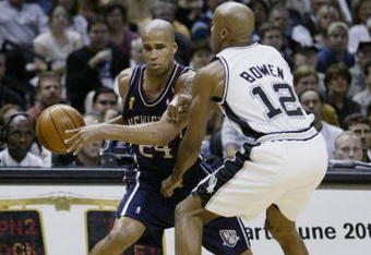 SAN ANTONIO, TX - JUNE 15:  Richard Jefferson #24 of the New Jersey Nets attempts to drive around Bruce Bowen #12 of the San Antonio Spurs in game six of the 2003 NBA Finals on June 15, 2003 at the SBC Center in San Antonio, Texas.  The Spurs won 88-77 and defeated the Nets to win the NBA Championship.  NOTE TO USER: User expressly acknowledges and agrees that, by downloading and/or using this Photograph, User is consenting to the terms and conditions of the Getty Images License Agreement.  (Photo by Ezra Shaw/Getty Images)