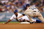 LOS ANGELES - JUNE 10: Juan Pierre #9 of the Los Angeles Dodgers slides into second with a stoloen base ahead of the tag of shortstop Josh Wilson #14 of the San Diego Padres in the first inning on June 10, 2009 at Dodger Stadium in Los Angeles, California.  (Photo by Stephen Dunn/Getty Images)