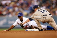 LOS ANGELES - JUNE 10: Juan Pierre #9 of the Los Angeles Dodgers slides into second with a stoloen base ahead of the tag of shortstop Josh Wilson #14 of the San Diego Padres in the first inning on June 10, 2009 at Dodger Stadium in Los Angeles, California.  (Photo by Stephen Dunn/Getty Images)