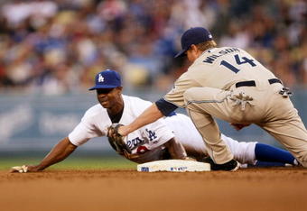 LOS ANGELES - JUNE 10: Juan Pierre #9 of the Los Angeles Dodgers slides into second with a stoloen base ahead of the tag of shortstop Josh Wilson #14 of the San Diego Padres in the first inning on June 10, 2009 at Dodger Stadium in Los Angeles, California.  (Photo by Stephen Dunn/Getty Images)