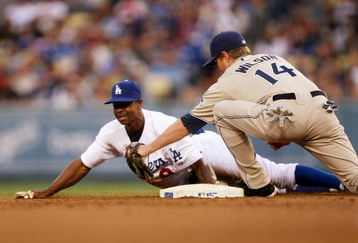 LOS ANGELES - JUNE 10: Juan Pierre #9 of the Los Angeles Dodgers slides into second with a stoloen base ahead of the tag of shortstop Josh Wilson #14 of the San Diego Padres in the first inning on June 10, 2009 at Dodger Stadium in Los Angeles, California.  (Photo by Stephen Dunn/Getty Images)