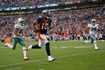 DENVER - NOVEMBER 02:  Wide receiver Brandon Marshall #15 of the Denver Broncos makes a reception and eludes the defense of Jason Allen #32 and Tyrone Culver #29 of the Miami Dolphins before being nulified by a penalty during NFL action at Invesco Field at Mile High on November 2, 2008 in Denver, Colorado. The Dolphins defeated the Broncos 26-17.  (Photo by Doug Pensinger/Getty Images)