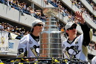 PITTSBURGH - JUNE 15:  Marc-Andre Fleury #29 and Sidney Crosby #87 of the Pittsburgh Penguins show off the Stanley Cup to the crowd on the Blvd of the Allies during the Stanley Cup Champion Victory Parade on June 15, 2009 in Pittsburgh, Pennsylvania.  (Photo by Jamie Sabau/Getty Images)