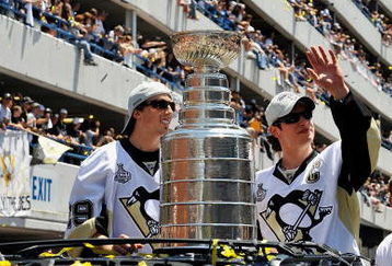 PITTSBURGH - JUNE 15:  Marc-Andre Fleury #29 and Sidney Crosby #87 of the Pittsburgh Penguins show off the Stanley Cup to the crowd on the Blvd of the Allies during the Stanley Cup Champion Victory Parade on June 15, 2009 in Pittsburgh, Pennsylvania.  (Photo by Jamie Sabau/Getty Images)