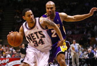 EAST RUTHERFORD, NJ - MARCH 27:  Devin Harris #34 of the New Jersey Nets drives against Derek Fisher #2 of the Los Angeles Lakers during the game on March 27, 2009 at the Izod Center in East Rutherford, New Jersey. NOTE TO USER: User expressly acknowledges and agrees that, by downloading and/or using this Photograph, User is consenting to the terms and conditions of the Getty Images License Agreement.  (Photo by Chris McGrath/Getty Images)