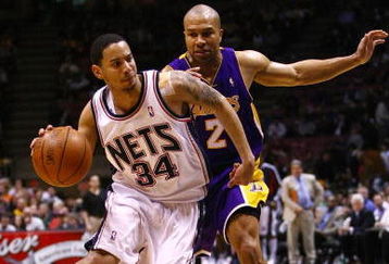 EAST RUTHERFORD, NJ - MARCH 27:  Devin Harris #34 of the New Jersey Nets drives against Derek Fisher #2 of the Los Angeles Lakers during the game on March 27, 2009 at the Izod Center in East Rutherford, New Jersey. NOTE TO USER: User expressly acknowledges and agrees that, by downloading and/or using this Photograph, User is consenting to the terms and conditions of the Getty Images License Agreement.  (Photo by Chris McGrath/Getty Images)