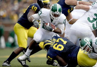 ANN ARBOR, MI - OCTOBER 25:  Javon Ringer #23 Michigan State Spartans looks for running room between Terrance Taylor #67 and John Thompson #49 of the Michigan Wolverines during a first quarter run on October 25, 2008 at Michigan Stadium in Ann Arbor, Michigan.  (Photo by Gregory Shamus/Getty Images)