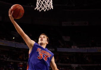 TAMPA, FL - MARCH 13:  Nick Calathes #33 of the Florida Gators makes a layup over Quantez Robertson #23 of the Auburn Tigers during the quaterfinal round of the SEC Men's Basketball Tournament on March 13, 2009 at The St. Pete Times Forum in Tampa, Florida.  (Photo by Chris Graythen/Getty Images)