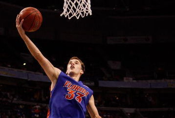 TAMPA, FL - MARCH 13:  Nick Calathes #33 of the Florida Gators makes a layup over Quantez Robertson #23 of the Auburn Tigers during the quaterfinal round of the SEC Men's Basketball Tournament on March 13, 2009 at The St. Pete Times Forum in Tampa, Florida.  (Photo by Chris Graythen/Getty Images)