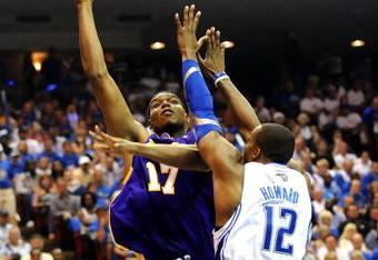 ORLANDO, FL - JUNE 14:  Andrew Bynum #17 of the Los Angeles Lakers goes up for a shot over Dwight Howard #12 of the Orlando Magic in the second quarter of Game Five of the 2009 NBA Finals on June 14, 2009 at Amway Arena in Orlando, Florida.  NOTE TO USER:  User expressly acknowledges and agrees that, by downloading and or using this photograph, User is consenting to the terms and conditions of the Getty Images License Agreement.  (Photo by Ronald Martinez/Getty Images)