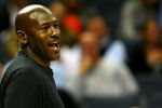 CHARLOTTE, NC - NOVEMBER 03:  Michael Jordan, part owner of the Charlotte Bobcats, smiles from the bench during their game against the Detroit Pistons at Time Warner Cable Arena on November 3, 2008 in Charlotte, North Carolina. NOTE TO USER: User expressly acknowledges and agrees that, by downloading and or using this photograph, User is consenting to the terms and conditions of the Getty Images License Agreement.  (Photo by Streeter Lecka/Getty Images)