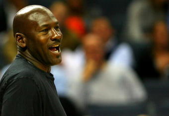 CHARLOTTE, NC - NOVEMBER 03:  Michael Jordan, part owner of the Charlotte Bobcats, smiles from the bench during their game against the Detroit Pistons at Time Warner Cable Arena on November 3, 2008 in Charlotte, North Carolina. NOTE TO USER: User expressly acknowledges and agrees that, by downloading and or using this photograph, User is consenting to the terms and conditions of the Getty Images License Agreement.  (Photo by Streeter Lecka/Getty Images)