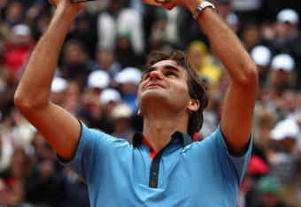 PARIS - JUNE 07:  Roger Federer of Switzerland lifts the trophy as he celebrates victory during the Men's Singles Final match against Robin Soderling of Sweden on day fifteen of the French Open at Roland Garros on June 7, 2009 in Paris, France.  (Photo by Ryan Pierse/Getty Images)