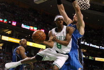 BOSTON - MAY 17:  Rajon Rondo #9 of the Boston Celtics passes the ball as Marcin Gortat #13 of the Orlando Magic defends Game Seven of the Eastern Conference Semifinals during the 2009 NBA Playoffs at TD Banknorth Garden on May 17, 2009 in Boston, Massachusetts. The Orlando Magic defeated the Boston Celtics 101-82 to advance to the Eastern Conference Finals. NOTE TO USER: User expressly acknowledges and agrees that, by downloading and or using this photograph, User is consenting to the terms and conditions of the Getty Images License Agreement.  (Photo by Elsa/Getty Images)