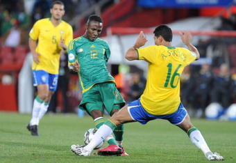 JOHANNESBURG, SOUTH AFRICA - JUNE 25:  Teko Modise of South Africa and Andre Santos of Brazil compete during the 2009 Confederations Cup semi-final match between South Africa and Brazil at Ellis Park on June 25, 2009 in Johannesburg, South Africa. (Photo by Lefty Shivambu/Gallo Images/Getty Images)