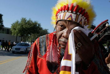 MIAMI - DECEMBER 03:  Washington Redskins 'unofficial' mascot Zema Williams known as Chief Zee wipes his face as he arrives for the funeral of Redskins football player, Sean Taylor, at the Pharmed Arena at Florida International University December 3, 2007 in Miami, Florida. Taylor died November 27, one day after being shot at his home in Miami.  (Photo by Joe Raedle/Getty Images)