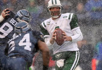 SEATTLE - DECEMBER 21:  Quarterback Brett Favre #4 of the New York Jets looks to pass under pressure from Rocky Bernard #99 of the Seattle Seahawks on December 21, 2008 at Qwest Field in Seattle, Washington. The Seahawks defeated the Jets 13-3. (Photo by Otto Greule Jr/Getty Images)