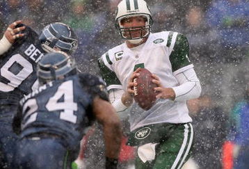 SEATTLE - DECEMBER 21:  Quarterback Brett Favre #4 of the New York Jets looks to pass under pressure from Rocky Bernard #99 of the Seattle Seahawks on December 21, 2008 at Qwest Field in Seattle, Washington. The Seahawks defeated the Jets 13-3. (Photo by Otto Greule Jr/Getty Images)