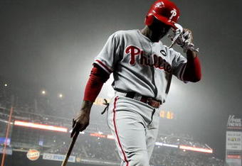 NEW YORK - JUNE 11: Jimmy Rollins #11 of the Philadelphia Phillies on deck to bat against the New York Mets on June 11, 2009 at Citi Field in the Flushing neighborhood of the Queens borough of New York City. (Photo by Nick Laham/Getty Images)