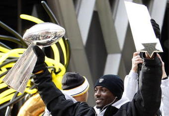 PITTSBURGH - FEBRUARY 03:  Santonio Holmes #10 of the Pittsburgh Steelers holds up his MVP and the Lombardi trophy after a parade to celebrate winning Super Bowl XLIII on February 3, 2009 in Pittsburgh, Pennsylvania.  (Photo by Gregory Shamus/Getty Images)