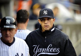 NEW YORK - JUNE 13:  Joe Girardi #27 of the New York Yankees walks through the dugout in a game against the New York Mets on June 13, 2009 at Yankee Stadium in the Bronx Borough of New York City.  (Photo by Jeff Zelevansky/Getty Images)