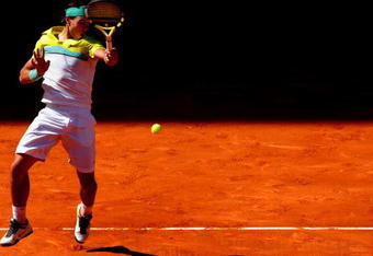 MADRID, SPAIN - MAY 16:  Rafael Nadal of Spain jumps to play a forehand to Novak Djokovic of Serbia in his semi-final match during the Madrid Open tennis tournament at the Caja Magica on May 16, 2009 in Madrid, Spain. Nadal won the match in three sets, 3-6, 7-6 and 7-6.  (Photo by Jasper Juinen/Getty Images)