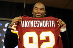 ASHBURN, VA - FEBRUARY 27:  Albert Haynesworth posese with his new jersey at a press conference after signing a 7-year contract worth approximately $100 million with the Washington Redskins on February 27, 2009 at Redskins Park in Ashburn, Virginia.  (Photo by Mitchell Layton/Getty Images)
