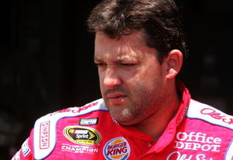 LOUDON, NH - JUNE 26:  Tony Stewart, driver of the #14 Old Spice/Office Depot Chevrolet, stands in the garage area during practice for the NASCAR Sprint Cup Series LENOX Industrial Tools 301 at New Hampshire Motor Speedway on June 26, 2009 in Loudon, New Hampshire.  (Photo by Jerry Markland/Getty Images for NASCAR)