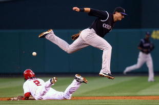 ANAHEIM, CA - JUNE 24:  Erick Aybar #2 of the Los Angeles Angels of Anaheim steals second base as the ball gets past shortstop Troy Tulowitzki #2 of the Colorado Rockies during the second inning at Angel Stadium June 24, 2009 in Anaheim, California. The Angels defeated the Rockies 11-3.  (Photo by Jeff Gross/Getty Images)
