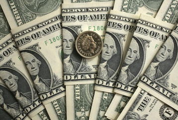 MANCHESTER, UNITED KINGDOM - APRIL 17:  In this photo illustration  British pound coins can be seen next to American Dollar notes on April 17, 2007 in  Manchester, England. The British pound has hit the two Dollar mark today in trading for the first time since September 1992 as well as trading at a 27-month low against the euro.  (Photo Illustration by  Christopher Furlong/Getty Images)