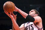 NEW YORK - MARCH 18: Brook Lopez #11 of the New Jersey Nets shoots over Wilson Chandler #21 of the New York Knicks at Madison Square Garden March 18, 2009 in New York City. NOTE TO USER: User expressly acknowledges and agrees that, by downloading and/or using this Photograph, User is consenting to the terms and conditions of the Getty Images License Agreement. (Photo by Chris McGrath/Getty Images)