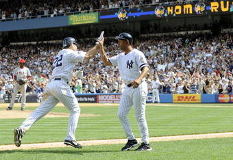 NEW YORK - AUGUST 03:  Xavier Nady #22 (L) and third base coach Bobby Meacham #50 of the New York Yankees celebrate Nady's three-run home run against the Los Angeles Angels of Anaheim on August 3, 2008 at Yankee Stadium in the Bronx borough of New York City. (Photo by Jeff Zelevansky/Getty Images)