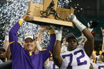 ATLANTA - DECEMBER 01:  Head coach Les Miles and Glenn Dorsey #72  of the Louisiana State University Tigers celebrate with the SEC trophy after defeating the University of Tennessee Volunteers 21-14 in the SEC Championship game on December 1, 2007 at the Georgia Dome in Atlanta, Georgia.  (Photo by Chris Graythen/Getty Images)