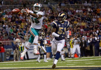 ST. LOUIS, MO. - NOVEMBER 30:  Davone Bess #15 of the Miami Dolphins attempts to make a touchdown catch against Will Witherspoon #51 of the St. Louis Rams at the Edward Jones Dome on November 30, 2008 in St. Louis, Missouri.  (Photo by Dilip Vishwanat/Getty Images)