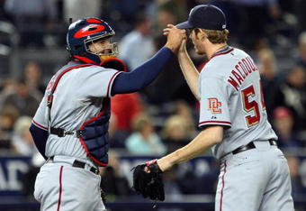 NEW YORK - JUNE 17:  Josh Bard #7 and Mike MacDougal #54 of the Washington Nationals celebrate after defeating the New York Yankees on June 17, 2009 at Yankee Stadium in the Bronx borough of New York City. The Nationals defeated the Yankees 3-2.  (Photo by Jim McIsaac/Getty Images)