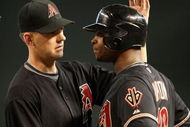 PHOENIX - MAY 30:  Manager A.J. Hinch of the Arizona Diamondbacks talks with Justin Upton #10 at first base after Upton had words with catcher David Ross (not pictured) of the Atlanta Braves during the major league baseball game at Chase Field on May 30, 2009 in Phoenix, Arizona.  (Photo by Christian Petersen/Getty Images)