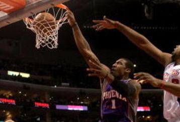 LOS ANGELES, CA - JANUARY 11: Amare Stoudemire #1 of the Phoenix Suns dunks between DeAndre Johnson #9 and Steve Novak #20 of the Los Angeles Clippers on January 11, 2009 at Staples Center in Los Angeles, California.  The Suns won 109-103.   NOTE TO USER: User expressly acknowledges and agrees that, by downloading and/or using this Photograph, user is consenting to the terms and conditions of the Getty Images License Agreement. (Photo by Stephen Dunn/Getty Images)