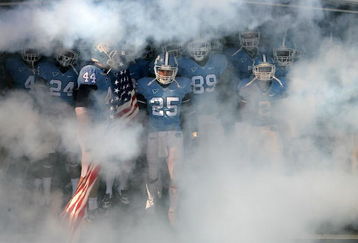 CHAPEL HILL, NC - NOVEMBER 22:  Matt Merletti #25 of the North Carolina Tar Heels carries the American Flag as he leads his team before the start of their game against the North Carolina State Wolfpack at Kenan Stadium on November 22, 2008 in Chapel Hill, North Carolina.  (Photo by Streeter Lecka/Getty Images)