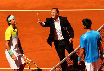 MADRID, SPAIN - MAY 16: Chair umpire Mohamed Lahyani tosses the coin at the net before the start of the  Novak Djokovic of Serbia against Rafael Nadal of Spain semi-final during the Madrid Open tennis tournament at the Caja Magica on May 16, 2009 in Madrid, Spain.  (Photo by Clive Brunskill/Getty Images)
