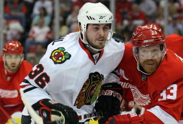 DETROIT - MAY 19:  Dave Bolland #36 of the Chicago Blackhawks fights for the puck on a face off against Kris Draper #33 of the Detroit Red Wings during Game Two of the Western Conference Championship Round of the 2009 Stanley Cup Playoffs on May 19, 2009 at Joe Louis Arena in Detroit, Michigan.  (Photo by Dave Sandford/Getty Images)