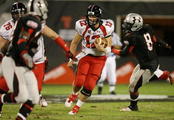 ORLANDO, FL - JANUARY 04:  Quarterback Richard Brehaut #12 of the white team looks for room to run behind offenssive lineman Kevin Graf #76 while avoiding a sack attempt by defensive end Dyron Dye #8 of the black team in the All America Under Armour Football Game at Florida Citrus Bowl on January 4, 2009 in Orlando, Florida.  (Photo by Doug Benc/Getty Images)