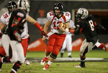 ORLANDO, FL - JANUARY 04:  Quarterback Richard Brehaut #12 of the white team looks for room to run behind offenssive lineman Kevin Graf #76 while avoiding a sack attempt by defensive end Dyron Dye #8 of the black team in the All America Under Armour Football Game at Florida Citrus Bowl on January 4, 2009 in Orlando, Florida.  (Photo by Doug Benc/Getty Images)