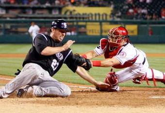 ANAHEIM, CA - JUNE 24:  Garrett Atkins #27 of the Colorado Rockies is tagged out at home by catcher Jeff Mathis #5 of the Los Angeles Angels of Anaheim during the eighth inning at Angel Stadium June 24, 2009 in Anaheim, California. The Angels defeated the Rockies 11-3.  (Photo by Jeff Gross/Getty Images)