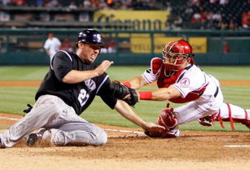 ANAHEIM, CA - JUNE 24:  Garrett Atkins #27 of the Colorado Rockies is tagged out at home by catcher Jeff Mathis #5 of the Los Angeles Angels of Anaheim during the eighth inning at Angel Stadium June 24, 2009 in Anaheim, California. The Angels defeated the Rockies 11-3.  (Photo by Jeff Gross/Getty Images)