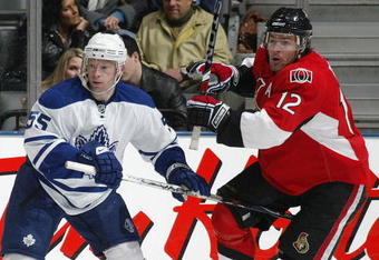 TORONTO - APRIL 11:  Jason Blake #55 of the Toronto Maple Leafs tries to hold up Mike Fisher #12 of the Ottawa Senators in a game on April 11, 2009 at the Air Canada Centre in Toronto, Ontario. The Leafs defeated the Senators on the strength of a 3 goal performance by Boyd Devereaux #22. (Photo by Claus Andersen/Getty Images) 