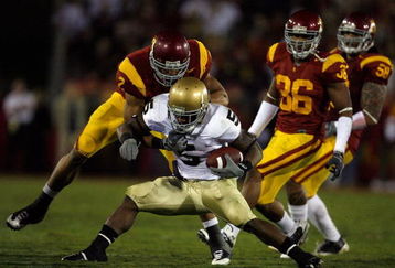 LOS ANGELES, CA - NOVEMBER 29:  Armando Allen #5 of the Nortre Dame Fighting Irsh is stopped by Taylor Mays #2, Josh Pinkard #36 and Rey Maualuga #58 of the USC Trojans during the second quarter at the Coliseum on November 29, 2008 in Los Angeles, California.  (Photo by Harry How/Getty Images)